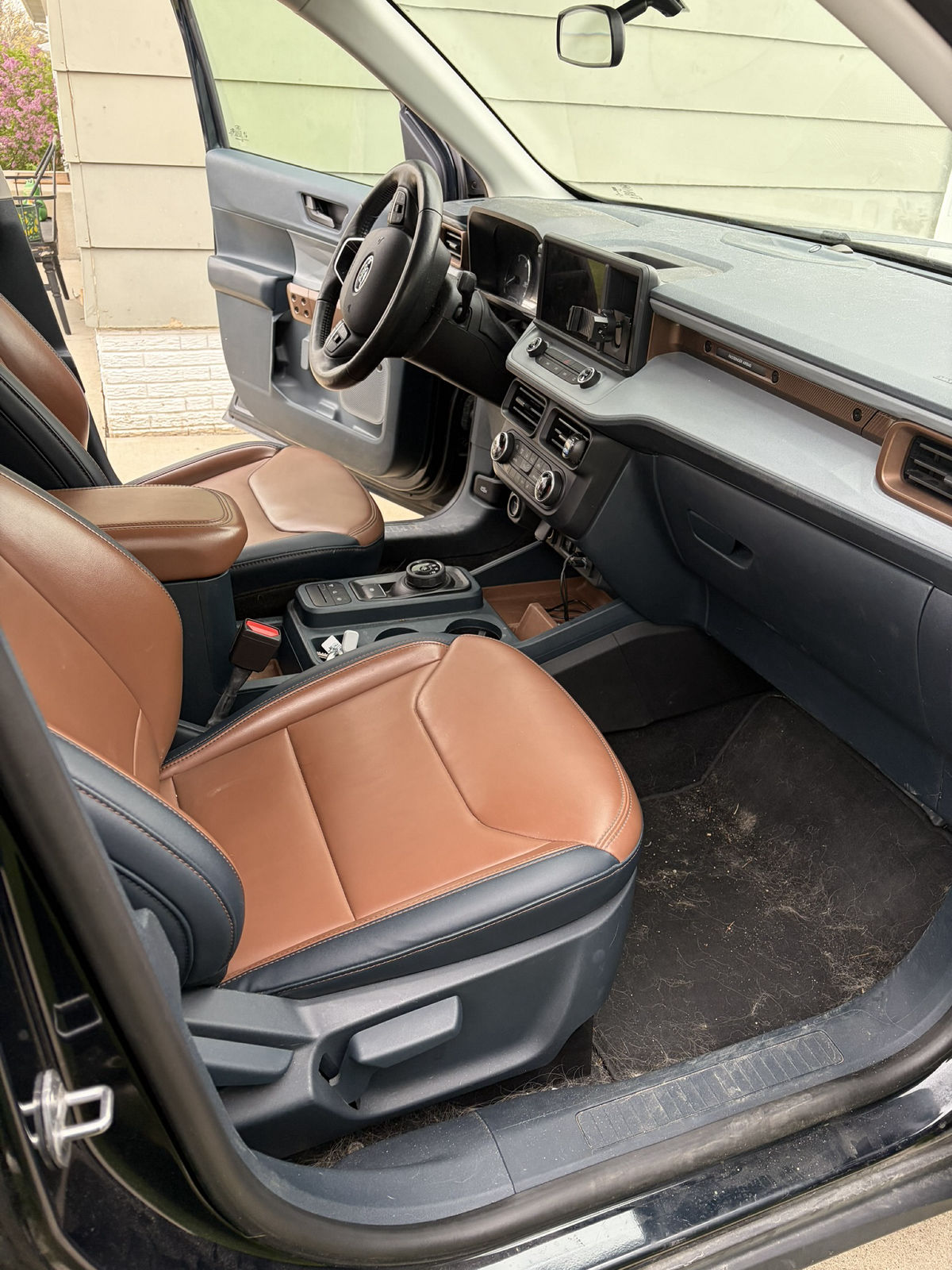 Professionally conditioned two-tone tan and black leather seats after interior detailing